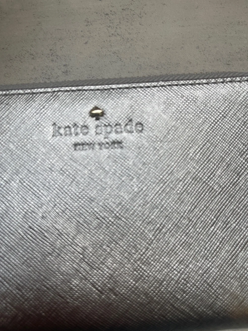 Kate Spade Laurie silver zip-around wristlet wallet
